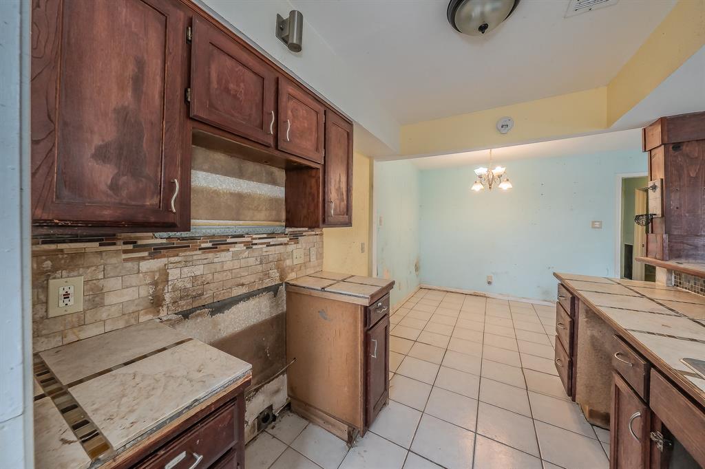 5709 Ranchogrande Drive Arlington, TX 76017 - Photo 14 of 28 a kitchen with a sink a stove and cabinets