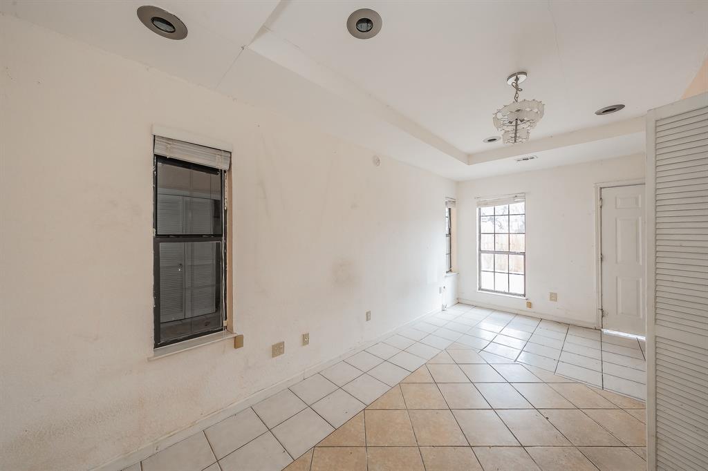 5709 Ranchogrande Drive Arlington, TX 76017 - Photo 28 of 28 a view of an empty room with window and cabinet