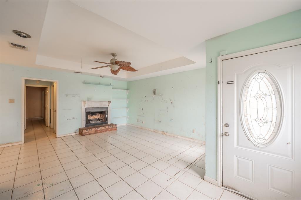 5709 Ranchogrande Drive Arlington, TX 76017 - Photo 5 of 28 a view of an empty room with window and a kitchen
