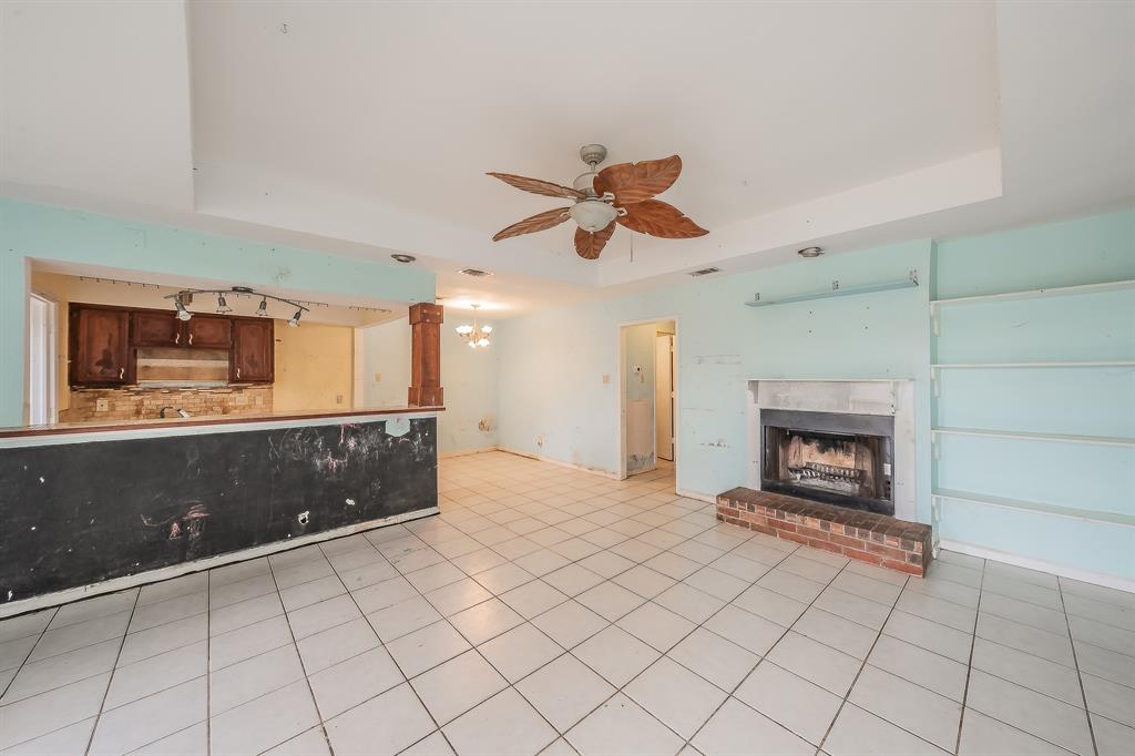 5709 Ranchogrande Drive Arlington, TX 76017 - Photo 6 of 28 a living room with furniture and a fireplace