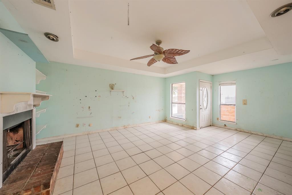 5709 Ranchogrande Drive Arlington, TX 76017 - Photo 8 of 28 a view of an empty room with window and fireplace