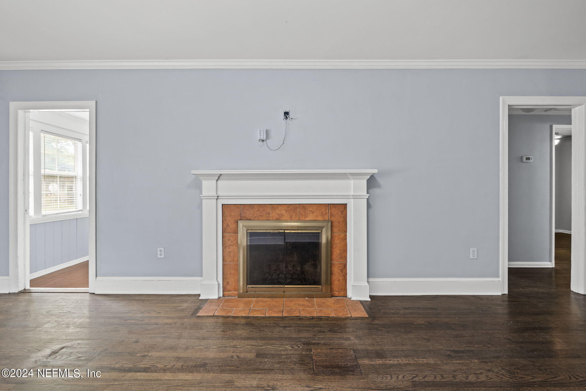 746 Hamilton Street Jacksonville, FL 32205 - Photo 12 of 28 a view of an empty room with wooden floor and a fireplace