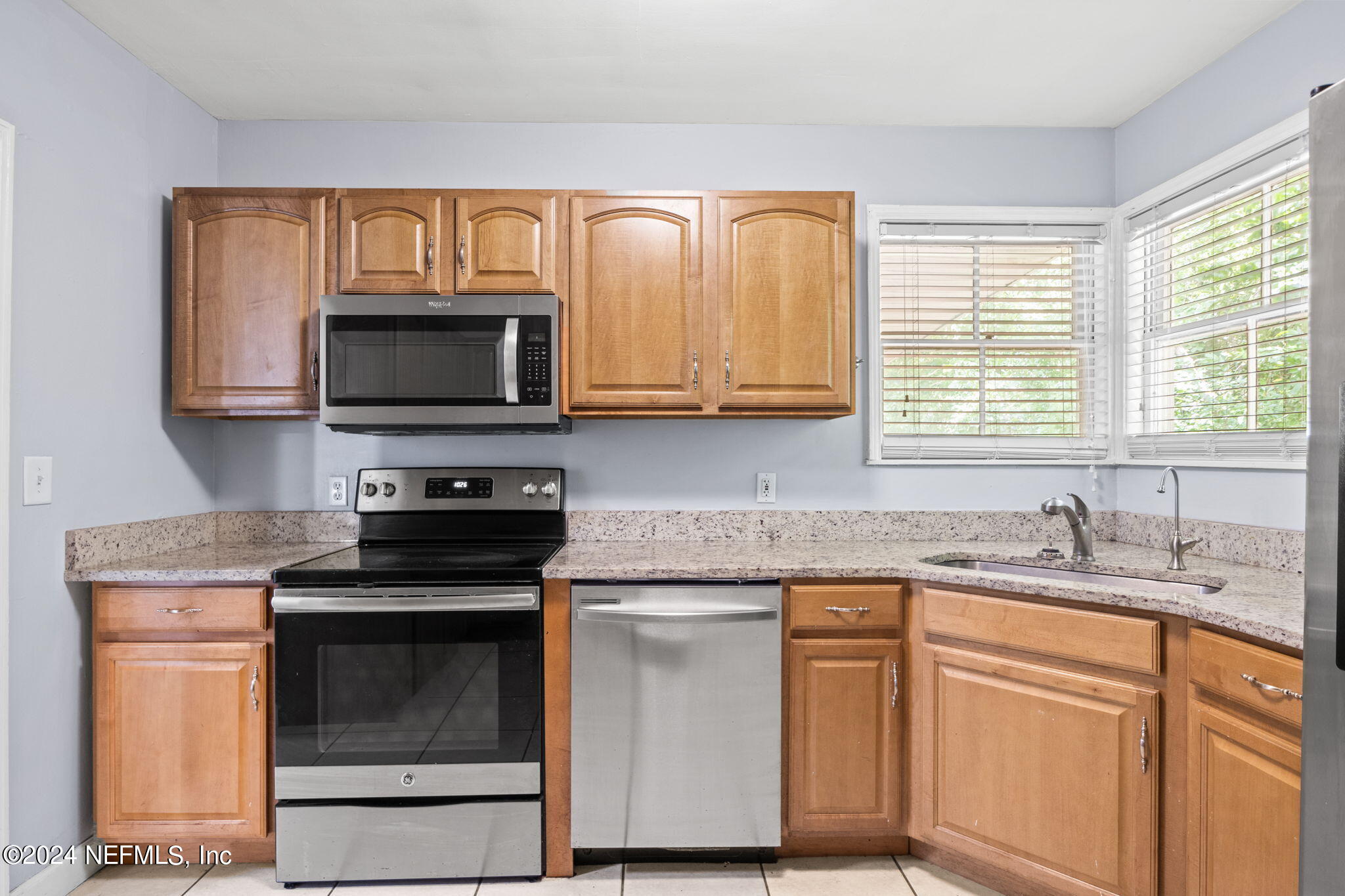 746 Hamilton Street Jacksonville, FL 32205 - Photo 16 of 28 a kitchen with granite countertop cabinets stainless steel appliances a sink and a window