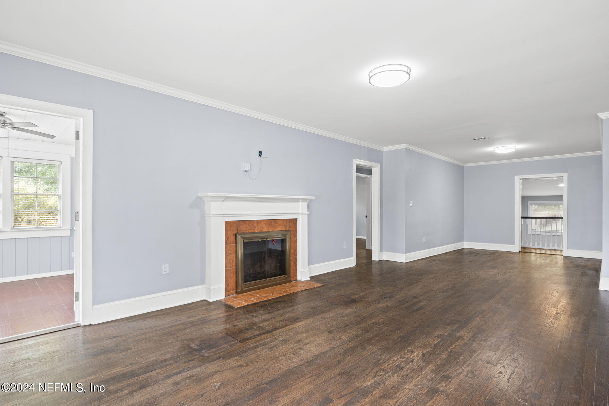 746 Hamilton Street Jacksonville, FL 32205 - Photo 3 of 28 an empty room with wooden floor fireplace and windows