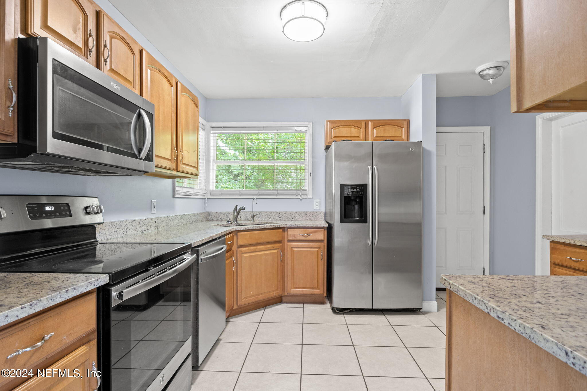 746 Hamilton Street Jacksonville, FL 32205 - Photo 4 of 28 a kitchen with granite countertop a sink stove and refrigerator