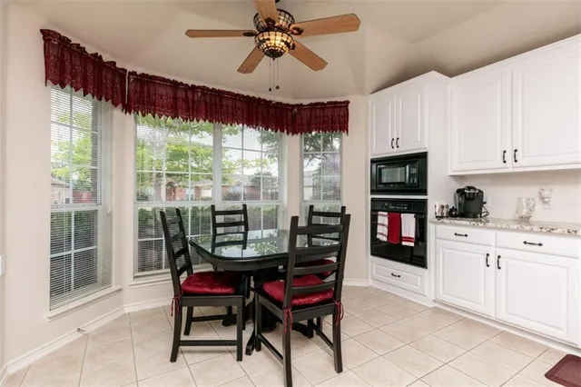a dining room with furniture a chandelier and window