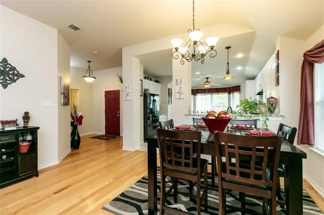 a view of a dining room with furniture and chandelier
