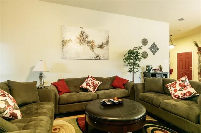 a living room with furniture and a white walls
