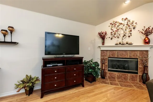 a living room with a fireplace and a flat screen tv