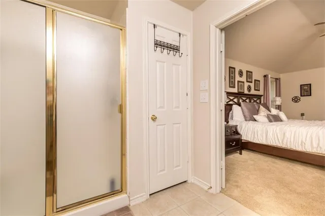 a bedroom with a bed and a painting on the wall