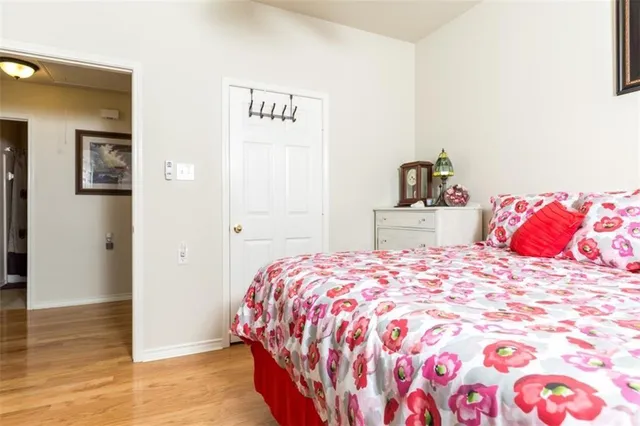 a bedroom with a bed and wooden floor