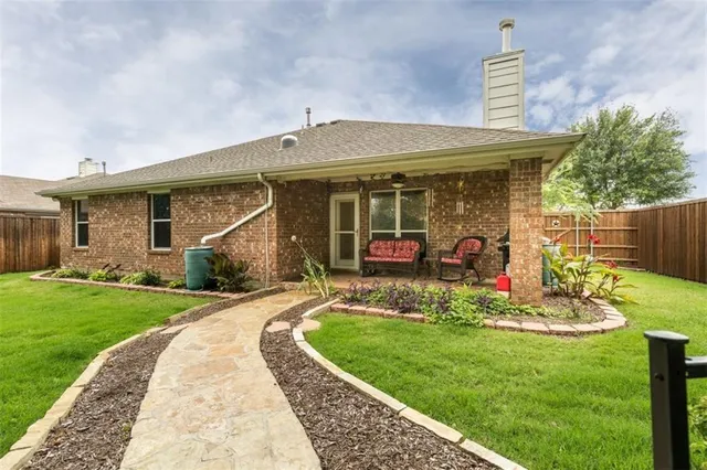 a front view of a house with a yard table and chairs