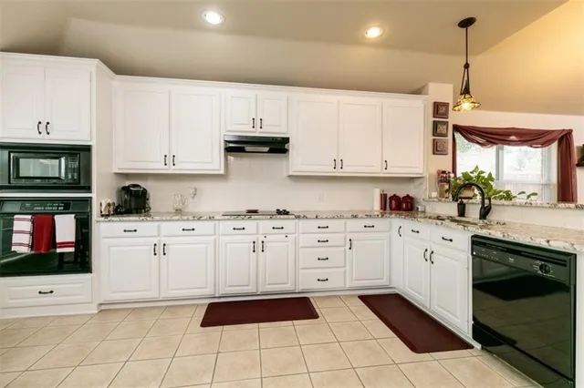 a kitchen with white cabinets a sink and white appliances