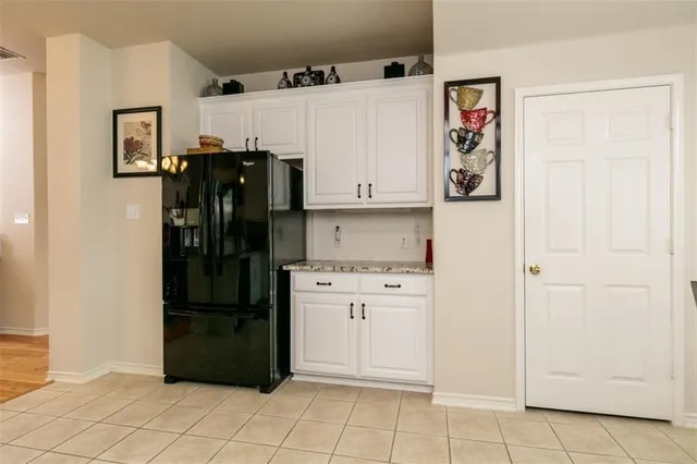 a kitchen with stainless steel appliances a refrigerator and cabinets
