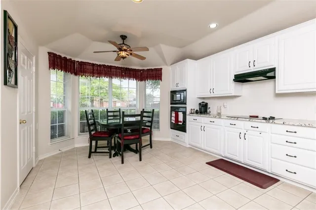 a kitchen with granite countertop cabinets stainless steel appliances a sink and a counter top space