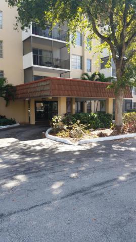 4160 Inverrary Drive, Unit 401 Lauderhill, FL 33319 - Photo 1 of 9 a front view of a house with a yard