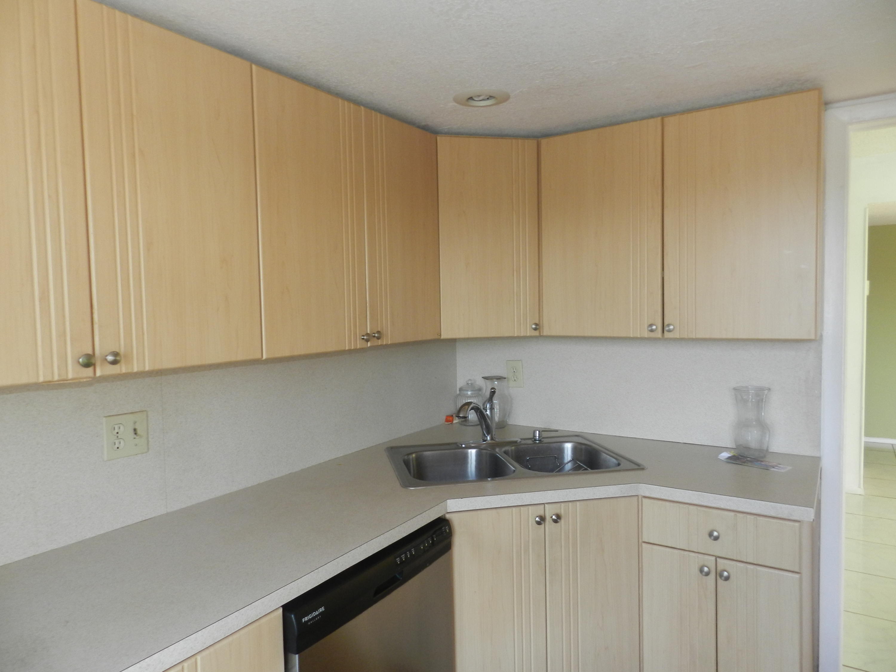 4160 Inverrary Drive, Unit 401 Lauderhill, FL 33319 - Photo 3 of 9 a kitchen with white cabinets and sink