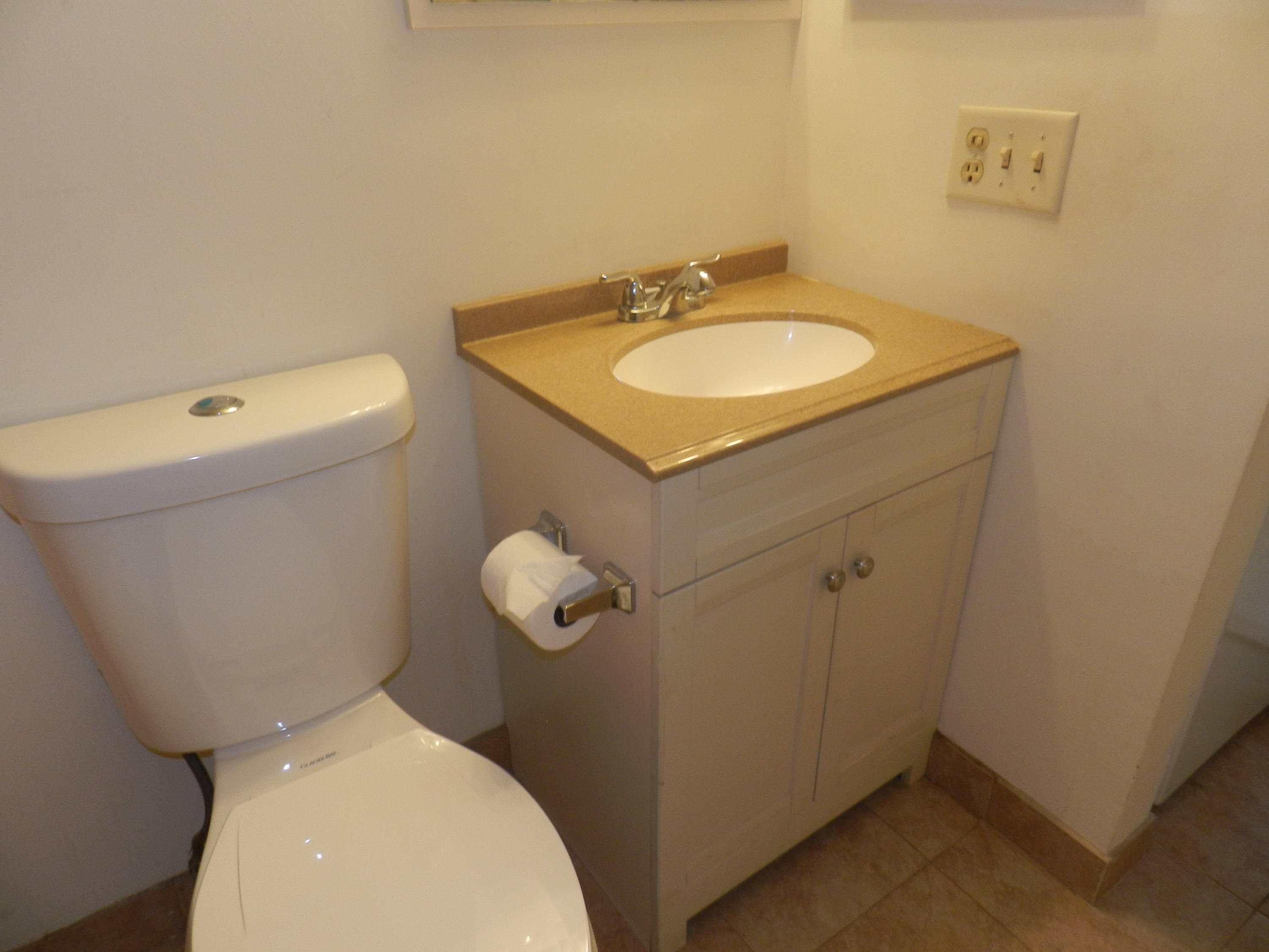 4160 Inverrary Drive, Unit 401 Lauderhill, FL 33319 - Photo 7 of 9 a bathroom with a toilet sink and mirror