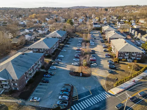 a large kitchen with cabinets and wooden floor