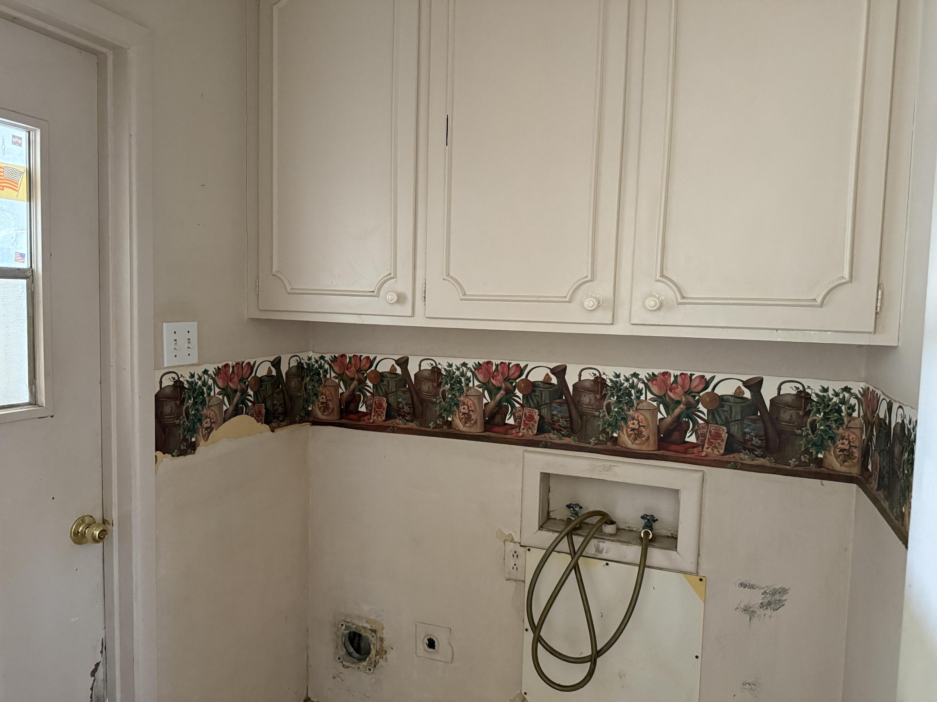 4418 58th Street Lubbock, TX 79414 - Photo 11 of 11 a close view of a utility room with washer and dryer