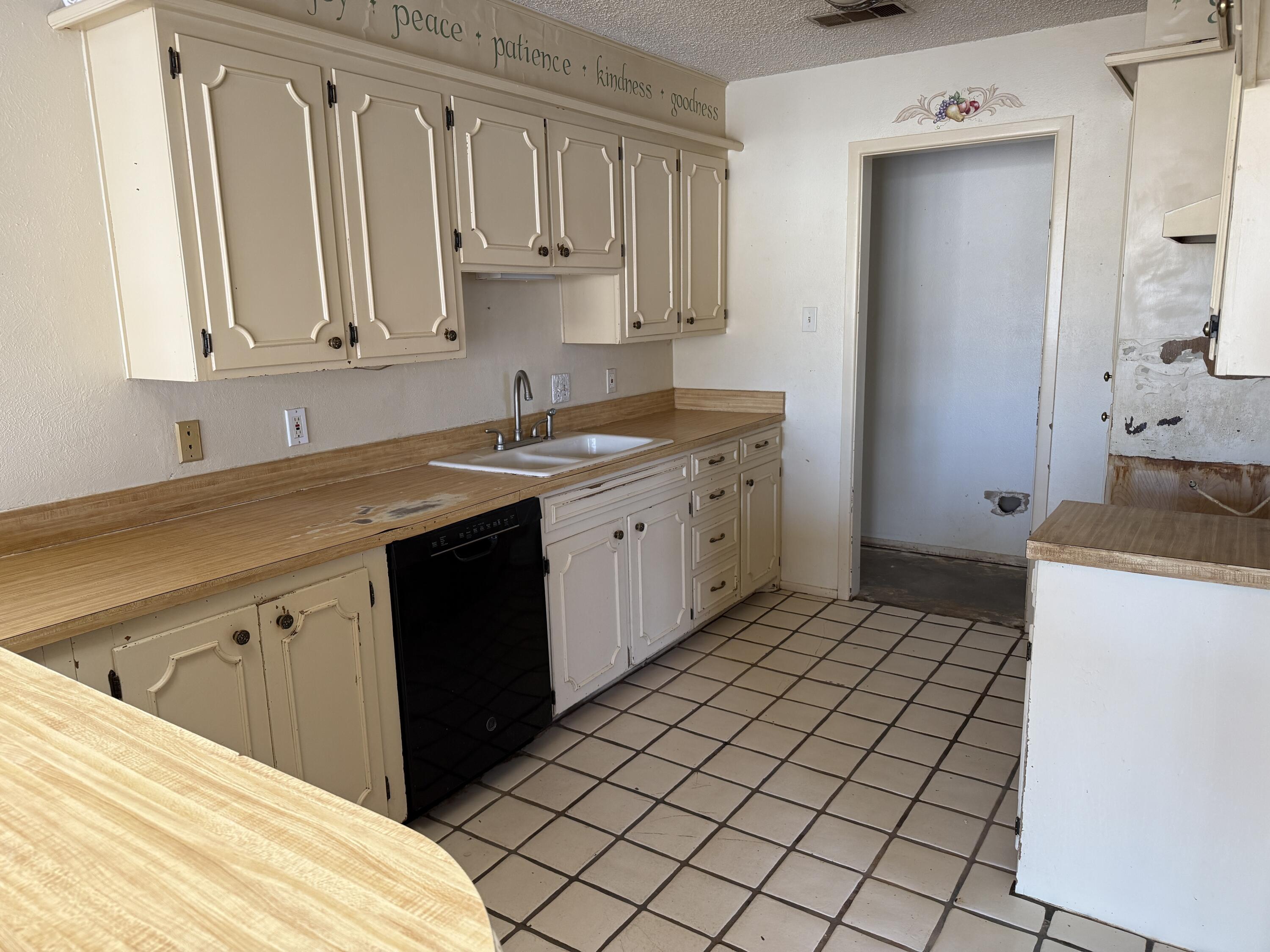 4418 58th Street Lubbock, TX 79414 - Photo 5 of 11 a kitchen with a sink stove and cabinets