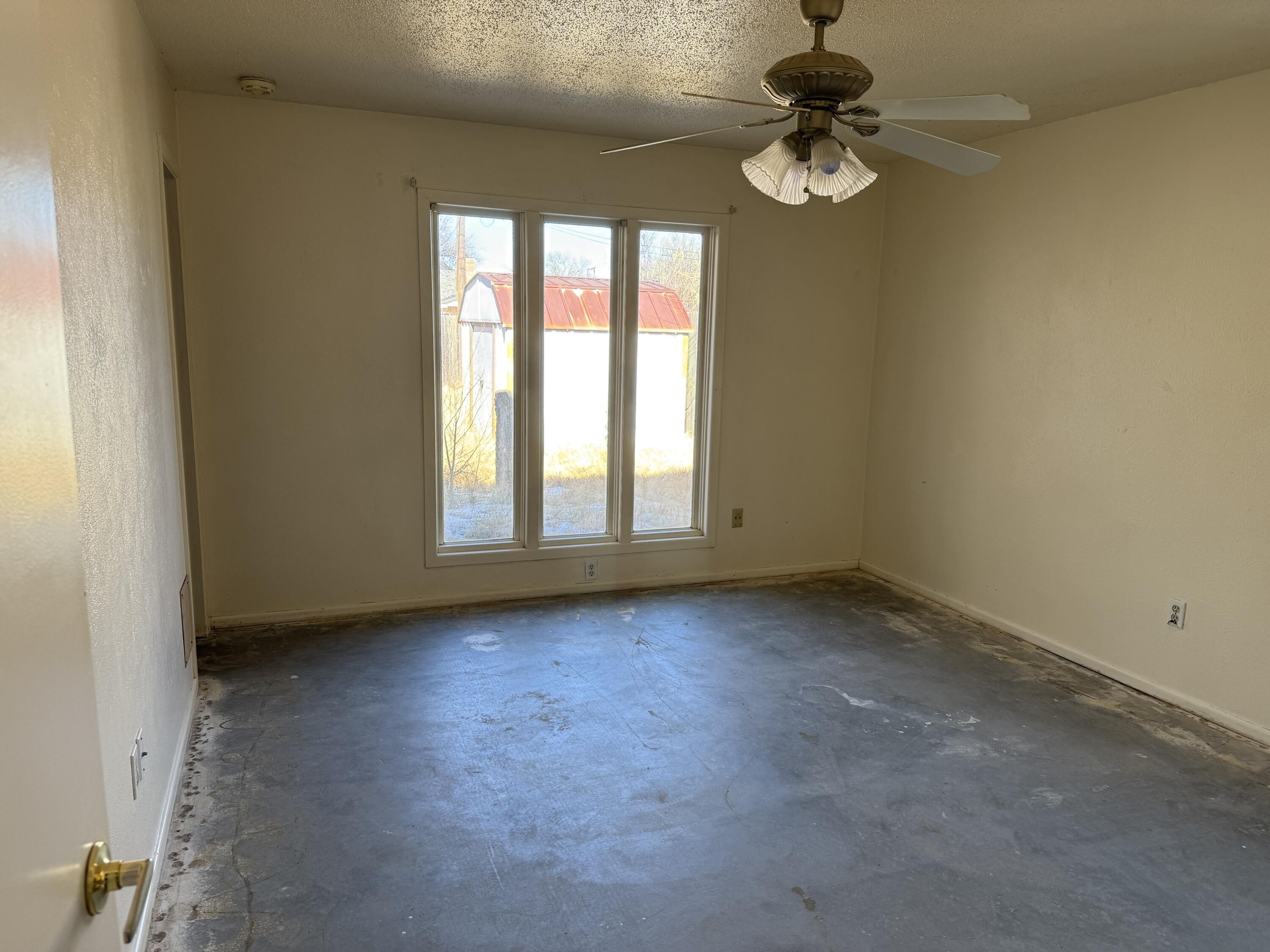 4418 58th Street Lubbock, TX 79414 - Photo 7 of 11 an empty room with windows and fan