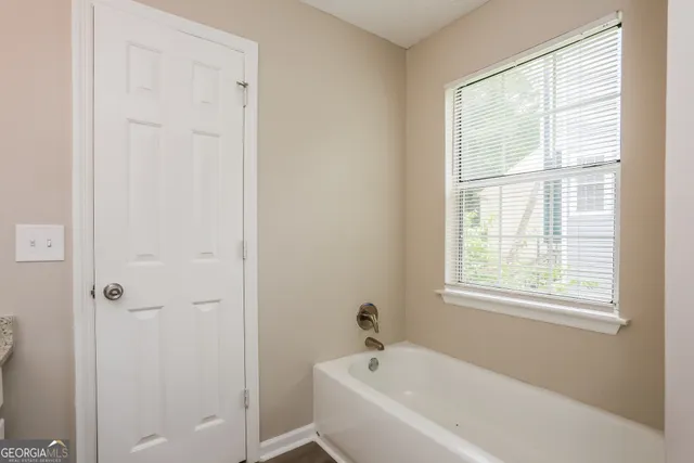 a white bath tub sitting next to a window