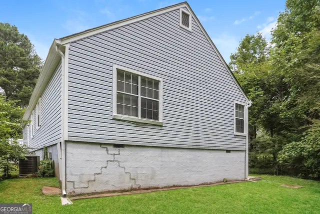 a view of a house with a yard and a garage