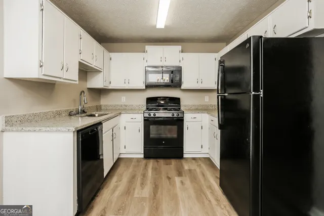 a kitchen with a refrigerator and a stove