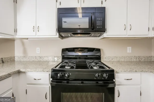 a stove top oven sitting inside of a kitchen