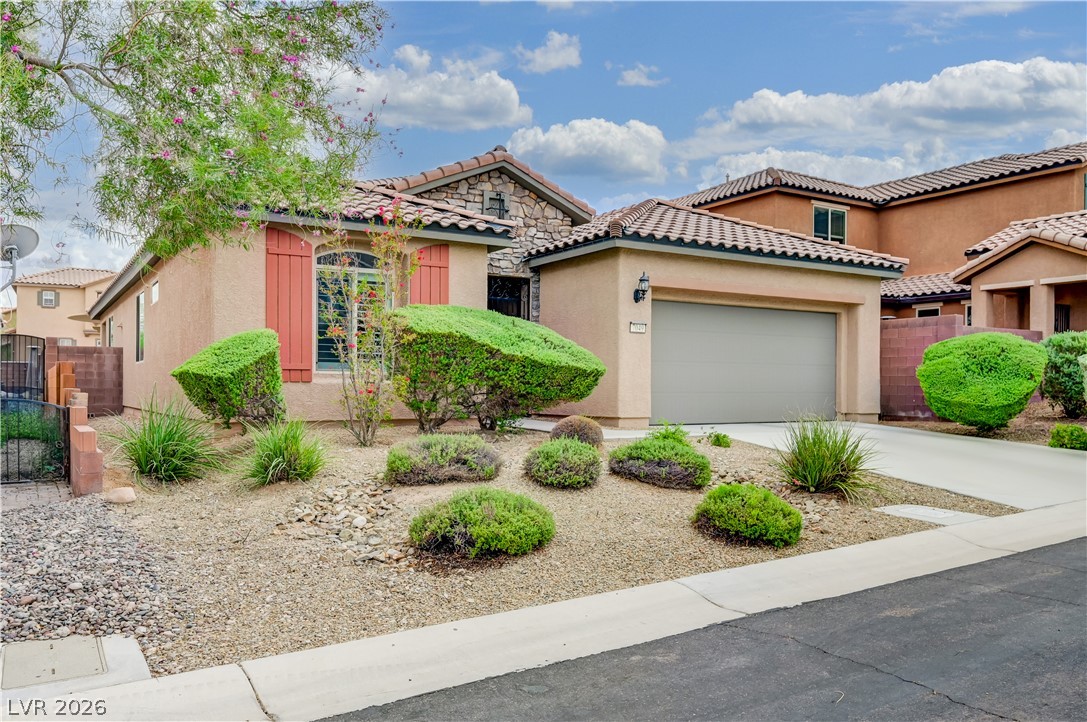 7049 Motley Road Las Vegas, NV 89178 - Photo 3 of 61 Spanish tile roofing and stone accents define this charming desert residence.