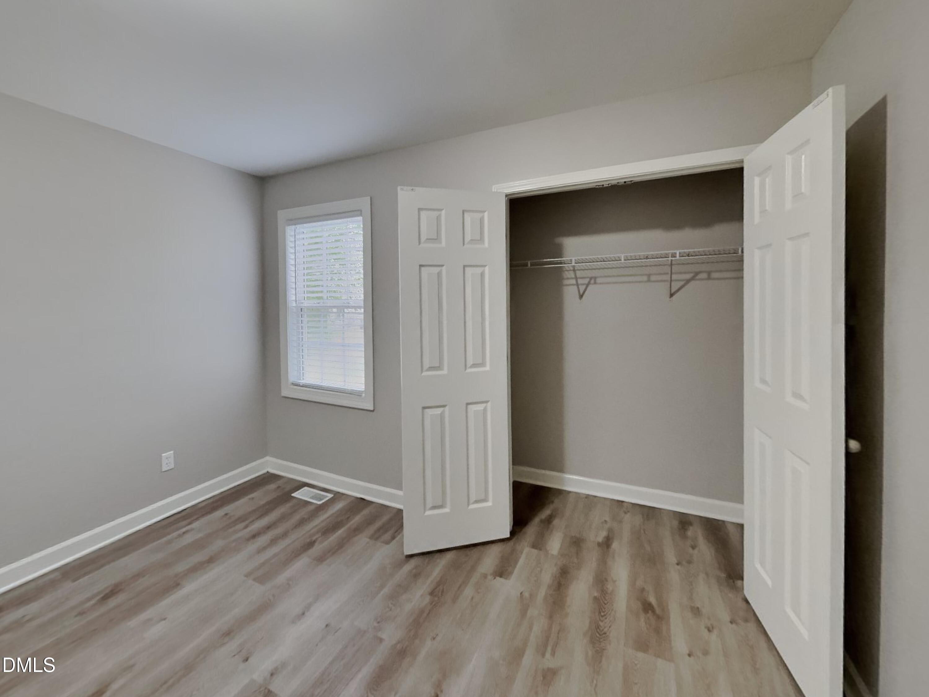 3224 Cotton Grove Raleigh, NC 27610 - Photo 10 of 15 a view of an empty room with wooden floor and closet