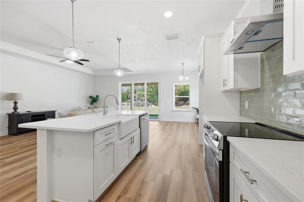 6718 Southwest 10th Lane Gainesville, FL 32607 - Photo 12 of 29 a kitchen with a sink stove and cabinets