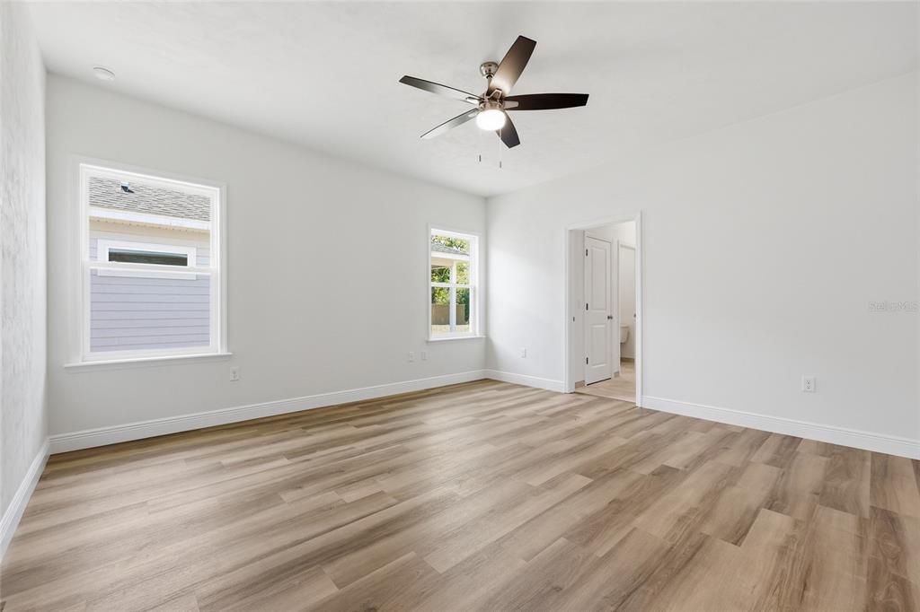 6718 Southwest 10th Lane Gainesville, FL 32607 - Photo 17 of 29 a view of empty room with wooden floor and ceiling fan