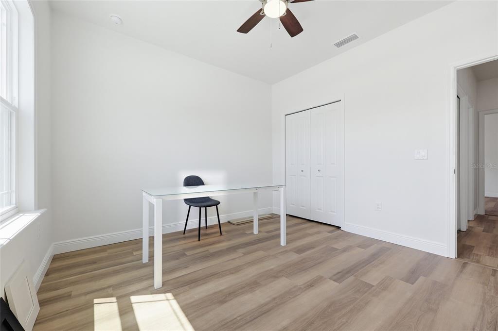 6718 Southwest 10th Lane Gainesville, FL 32607 - Photo 20 of 29 an empty room with a wooden floor and windows