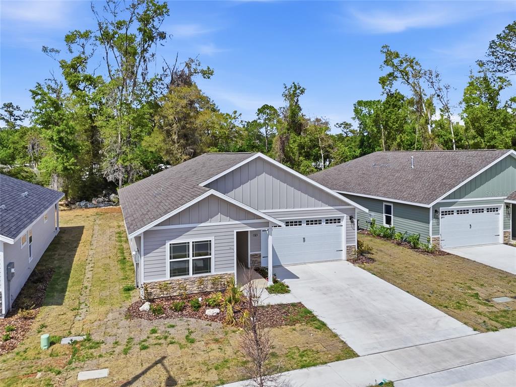 6718 Southwest 10th Lane Gainesville, FL 32607 - Photo 2 of 29 a view of a yard in front of a house with large trees