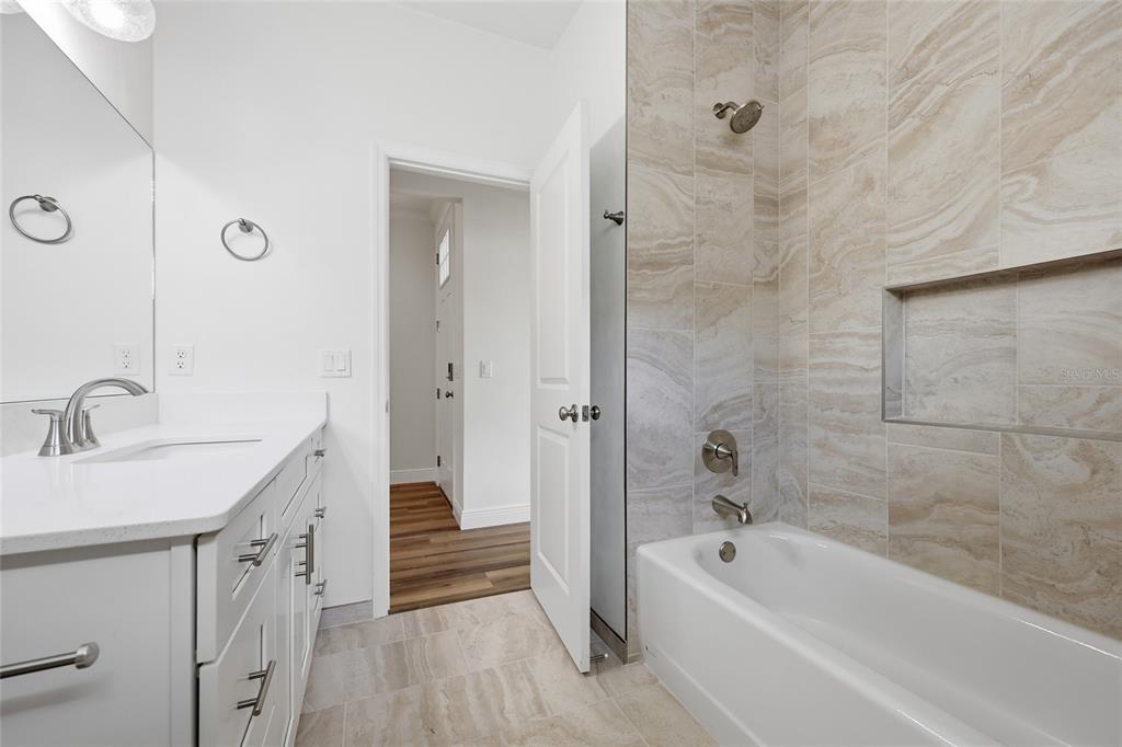 6718 Southwest 10th Lane Gainesville, FL 32607 - Photo 22 of 29 a bathroom with a bathtub a sink a vanity and a shower