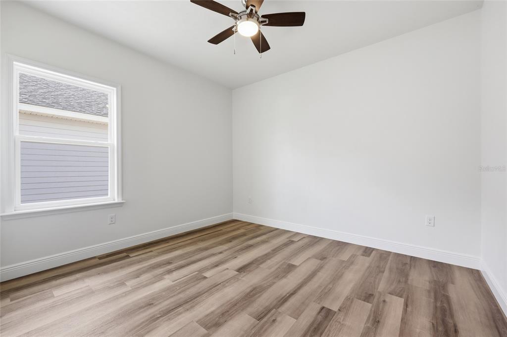 6718 Southwest 10th Lane Gainesville, FL 32607 - Photo 23 of 29 an empty room with a window and a fan