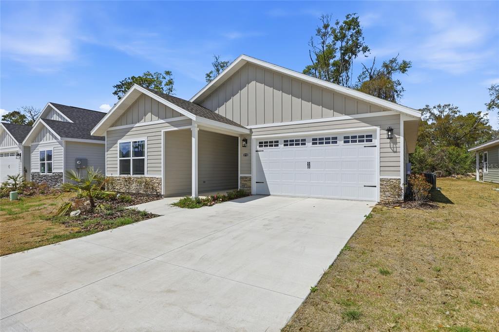 6718 Southwest 10th Lane Gainesville, FL 32607 - Photo 28 of 29 a view of a white house with a yard