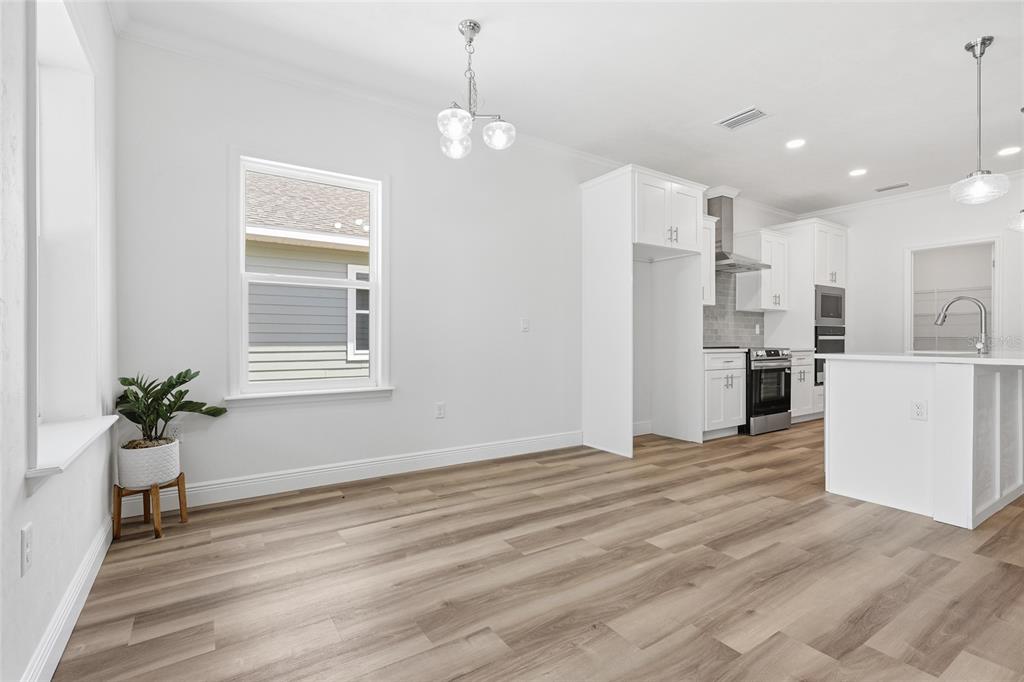 6718 Southwest 10th Lane Gainesville, FL 32607 - Photo 4 of 29 a view of a kitchen with kitchen island wooden floor center island and stainless steel appliances
