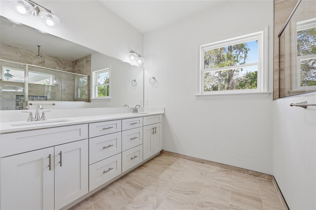 6718 Southwest 10th Lane Gainesville, FL 32607 - Photo 6 of 29 a spacious bathroom with 2 sink tub and a mirror