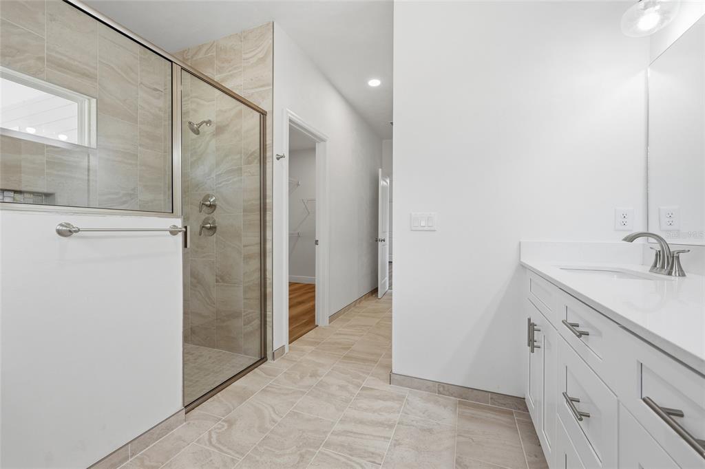 6718 Southwest 10th Lane Gainesville, FL 32607 - Photo 7 of 29 a bathroom with a granite countertop sink mirror and shower