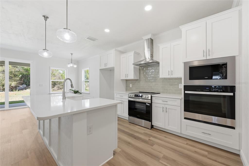 6718 Southwest 10th Lane Gainesville, FL 32607 - Photo 10 of 29 a kitchen with stainless steel appliances a stove a sink and a microwave