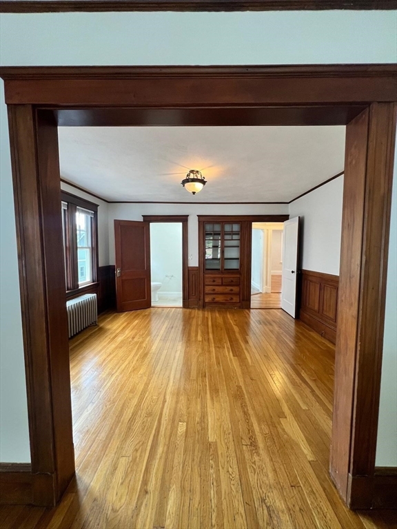 96 Brooks Street, Unit 1 Boston, MA 02135 - Photo 3 of 15 a view of empty room with wooden floor and fan