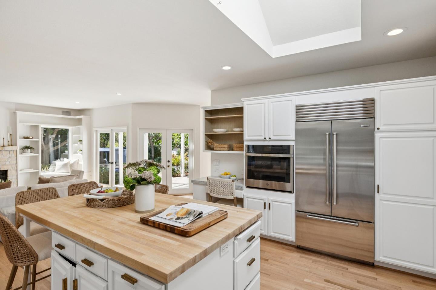 5700 Carmel Valley Road Carmel, CA 93923 - Photo 16 of 66 a kitchen with a stove a refrigerator and a dining table with wooden floor