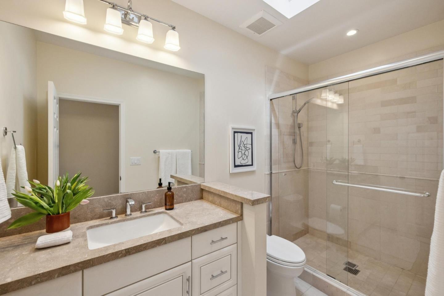 5700 Carmel Valley Road Carmel, CA 93923 - Photo 29 of 66 a bathroom with a granite countertop sink a toilet a large mirror and shower