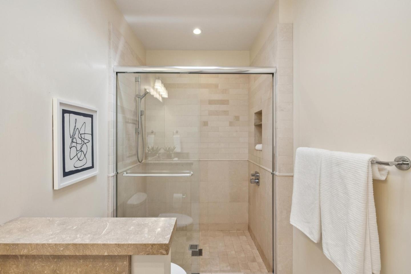 5700 Carmel Valley Road Carmel, CA 93923 - Photo 30 of 66 a bathroom with a shower and a glass door