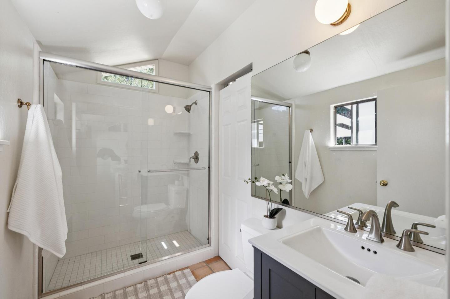 5700 Carmel Valley Road Carmel, CA 93923 - Photo 41 of 66 a bathroom with a sink mirror toilet and shower