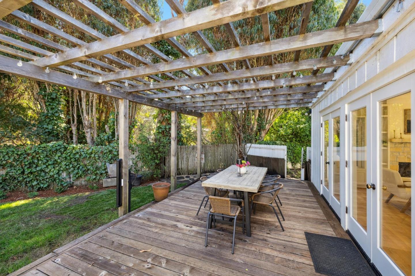 5700 Carmel Valley Road Carmel, CA 93923 - Photo 43 of 66 a roof deck with table and chairs and a barbeque with wooden floor