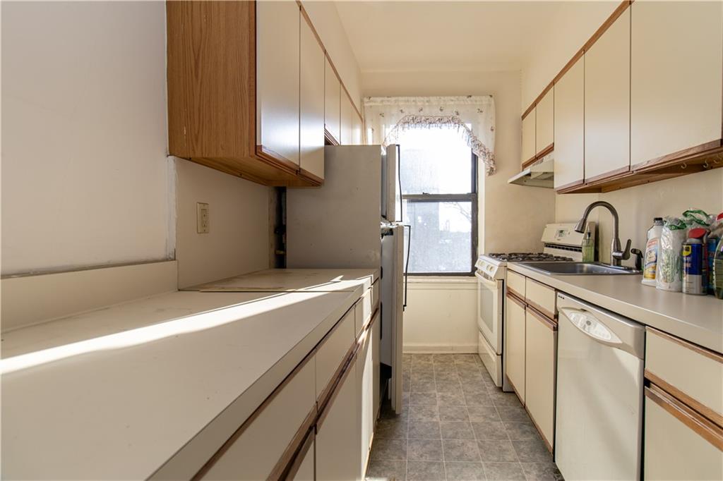 359 Ovington Avenue, Unit D2 Brooklyn, NY 11209 - Photo 12 of 25 a kitchen with stainless steel appliances a sink and a refrigerator